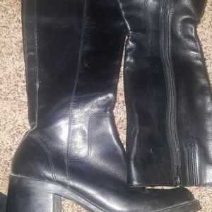 Black leather boot stops at knee. Barely worn